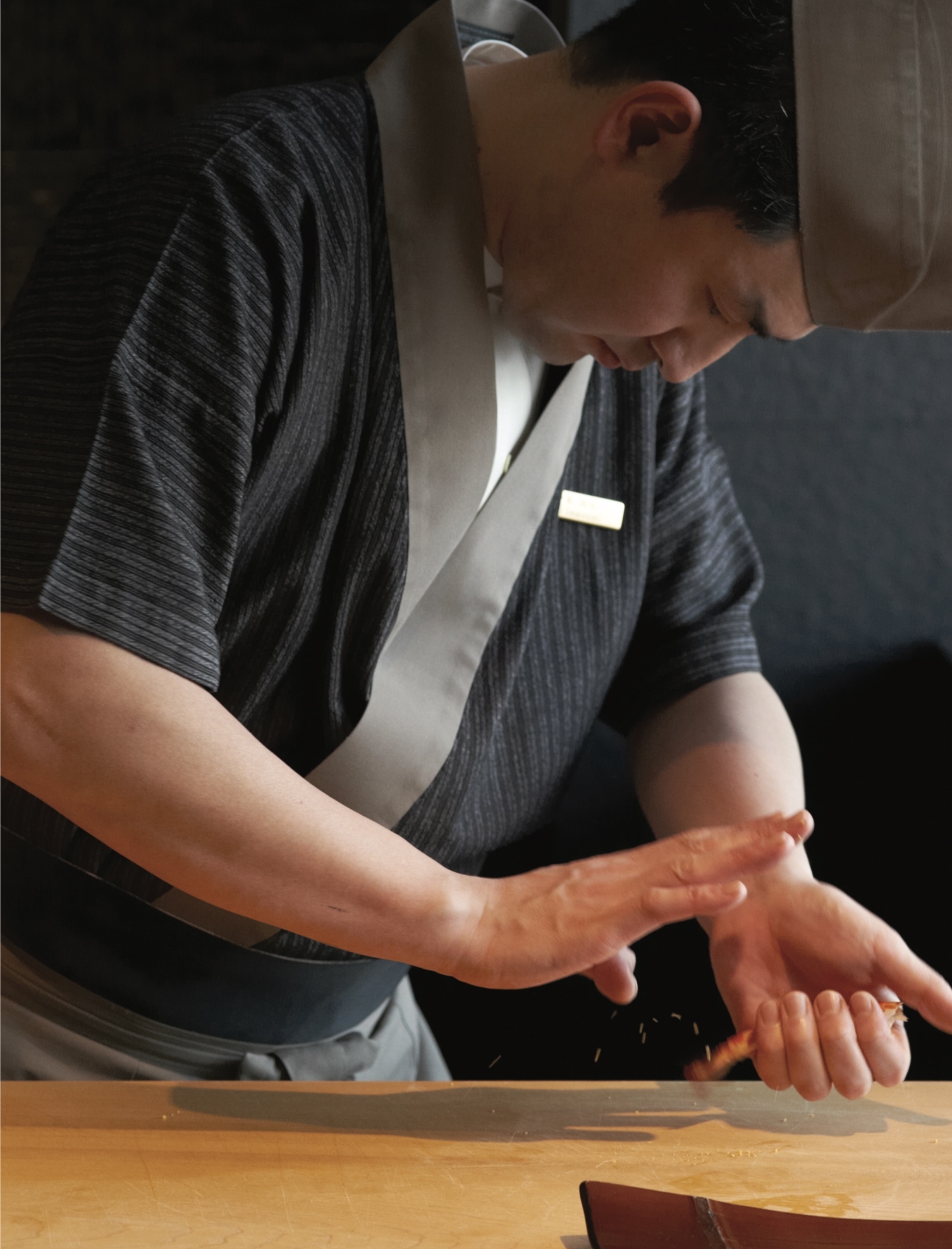 sushi chef, concentrated, was in preparation of the delectable nigiri sushi
