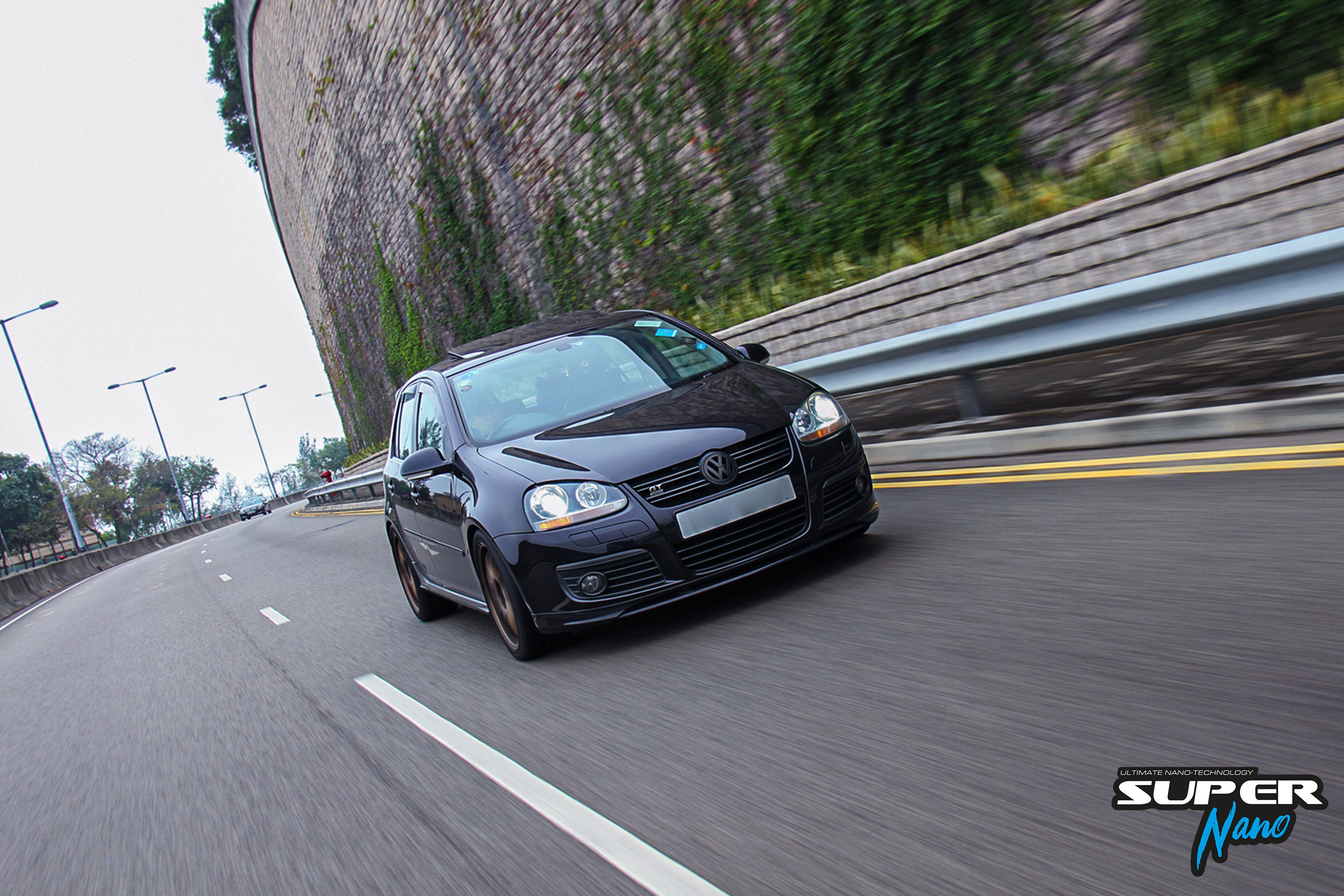 black volkswagen golf gt mk5 hong kong travelling on highway