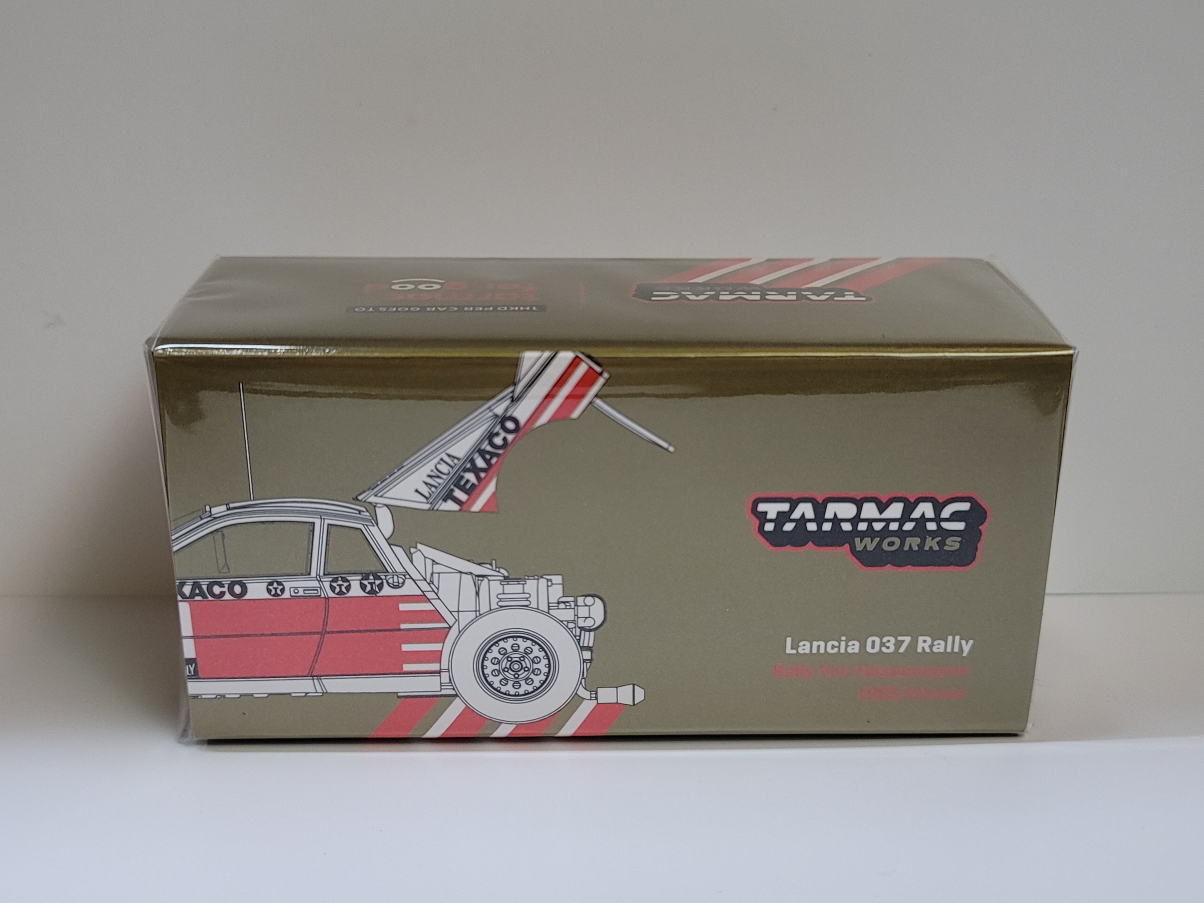 Tarmac Works - 1/64 Lancia 037 Rally - Rally Van Haspengouw 1985 Winner - with Opening Rear Bonnet A Tarmac Works - 1/64 Lancia 037 Rally - Rally Van Haspengouw 1985 Winner - with Opening Rear Bonnet A