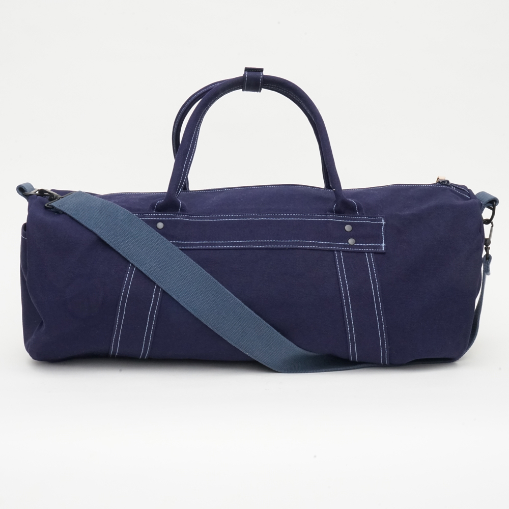 漲流木深紫色帆布大容量旅行包，多隔層設計，耐用帆布材質，適合長途旅行與日常使用