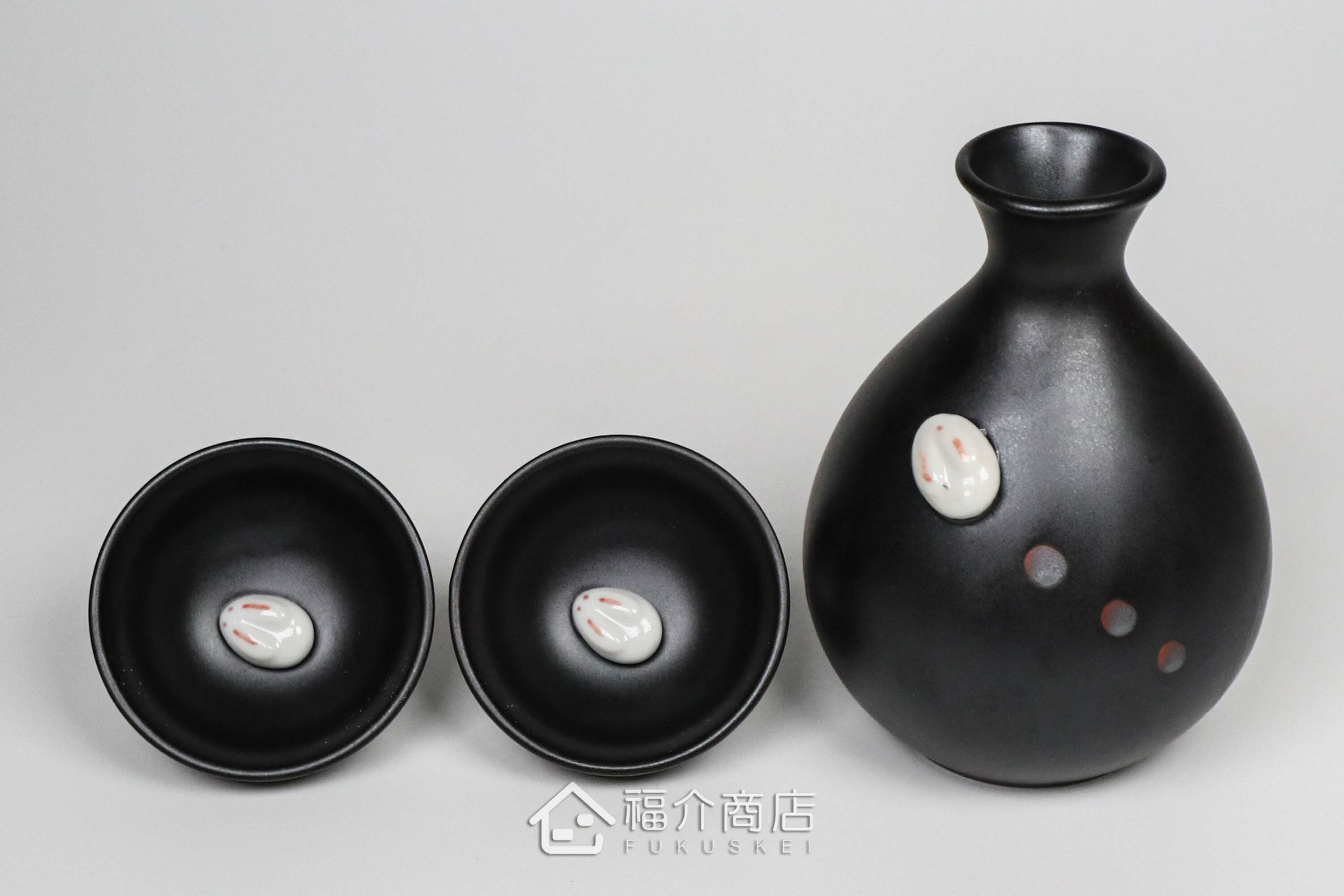 杯內有白兔造型的黑色清酒杯與黑色的月兔造型清酒壺