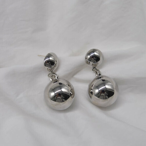 A metal ball is hung from the ear