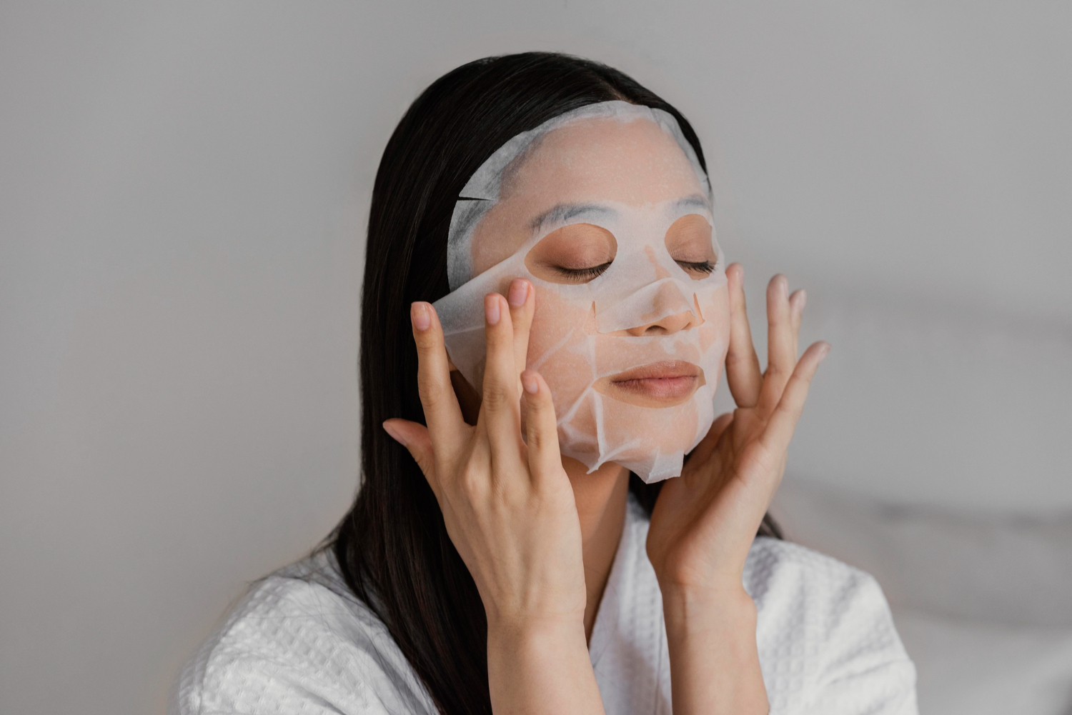 Asian woman using a sheet mask