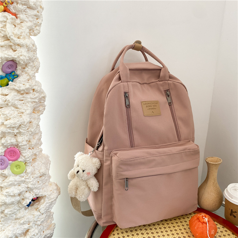 New large-capacity travel outdoor backpack and computer bag (pink [with blush bear pendant])