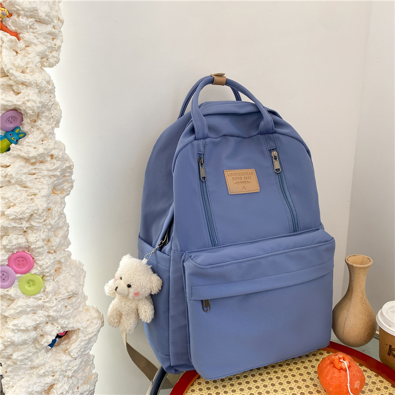 New large-capacity travel outdoor backpack and computer bag (blue [with blush bear pendant])