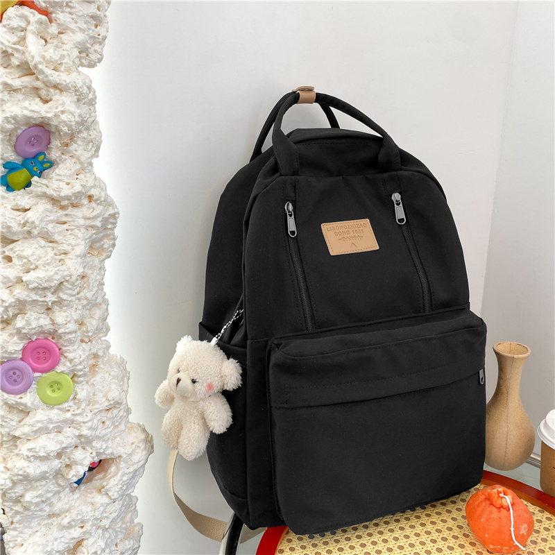 New large-capacity travel outdoor backpack and computer bag (black [with blush bear pendant])