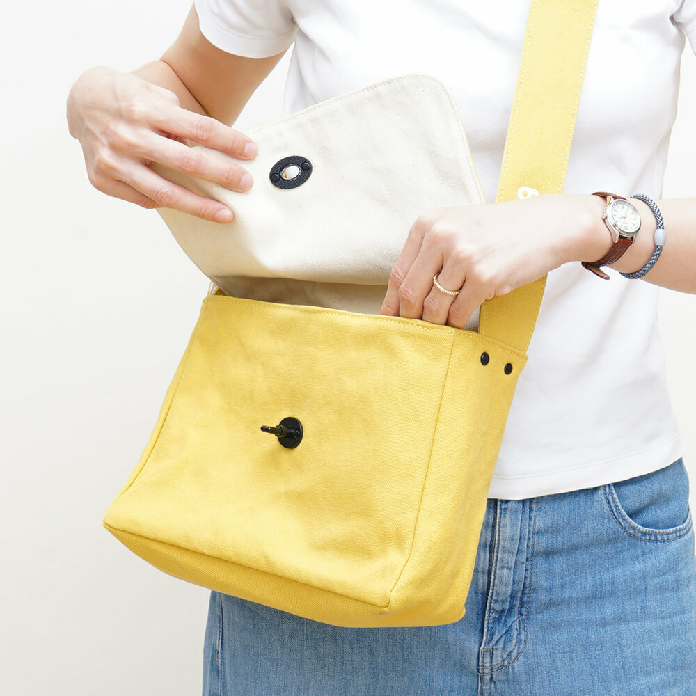 May 蘑菇經典小書包，素色帆布材質，翻蓋搭配磁扣設計，附前袋與內層收納，小巧輕便，適合日常外出使用