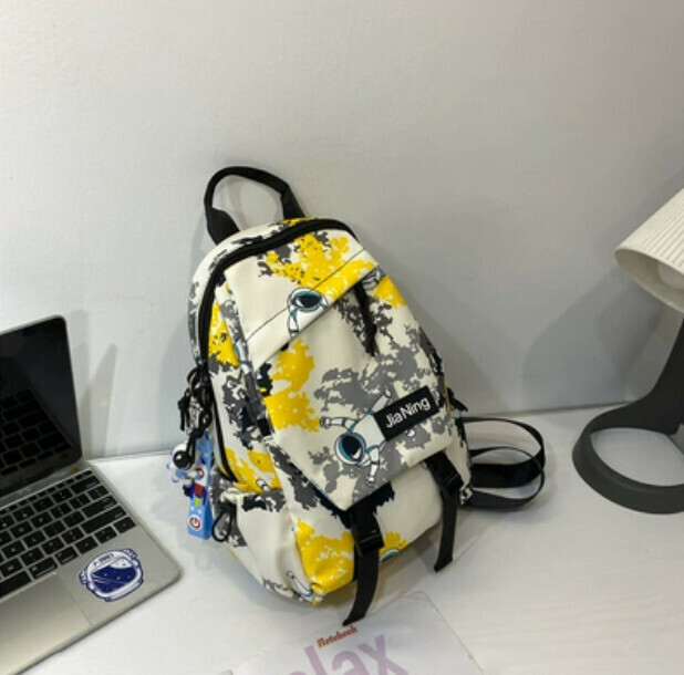 Popular crossbody bag for men, trendy canvas chest bag (yellow with astronaut pendant)