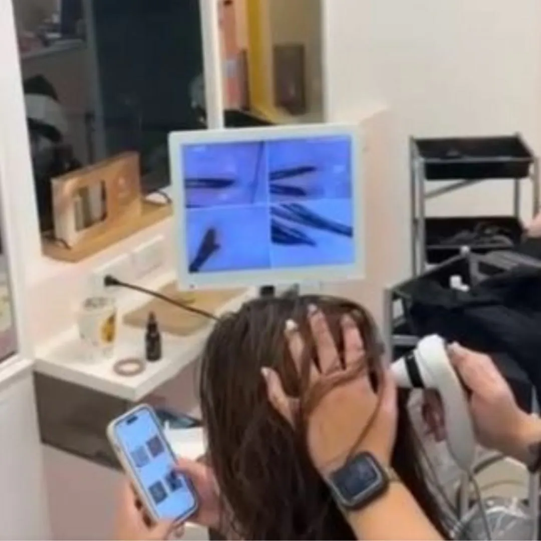 Betty conducts scalp analysis for clients