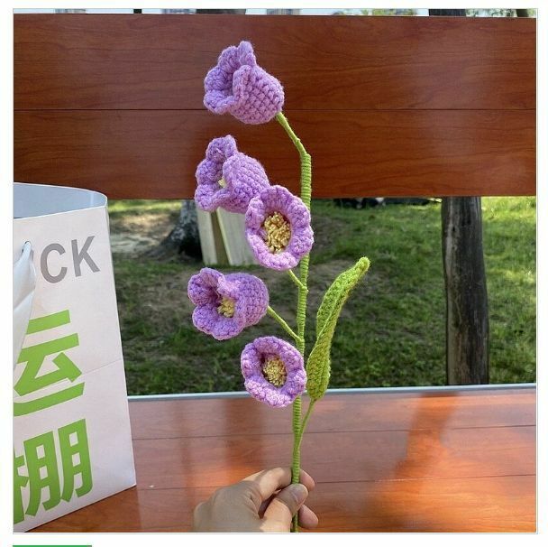 New wool hand-knitted crochet flower product (a purple lily of the valley flower)