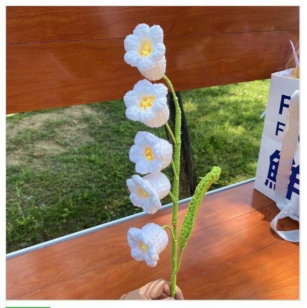 New wool hand-knitted crochet flower product (a white lily of the valley flower)