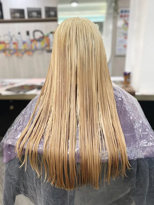 When bleaching hair, if the strands cannot lighten to a clean platinum base, it's often due to color build up