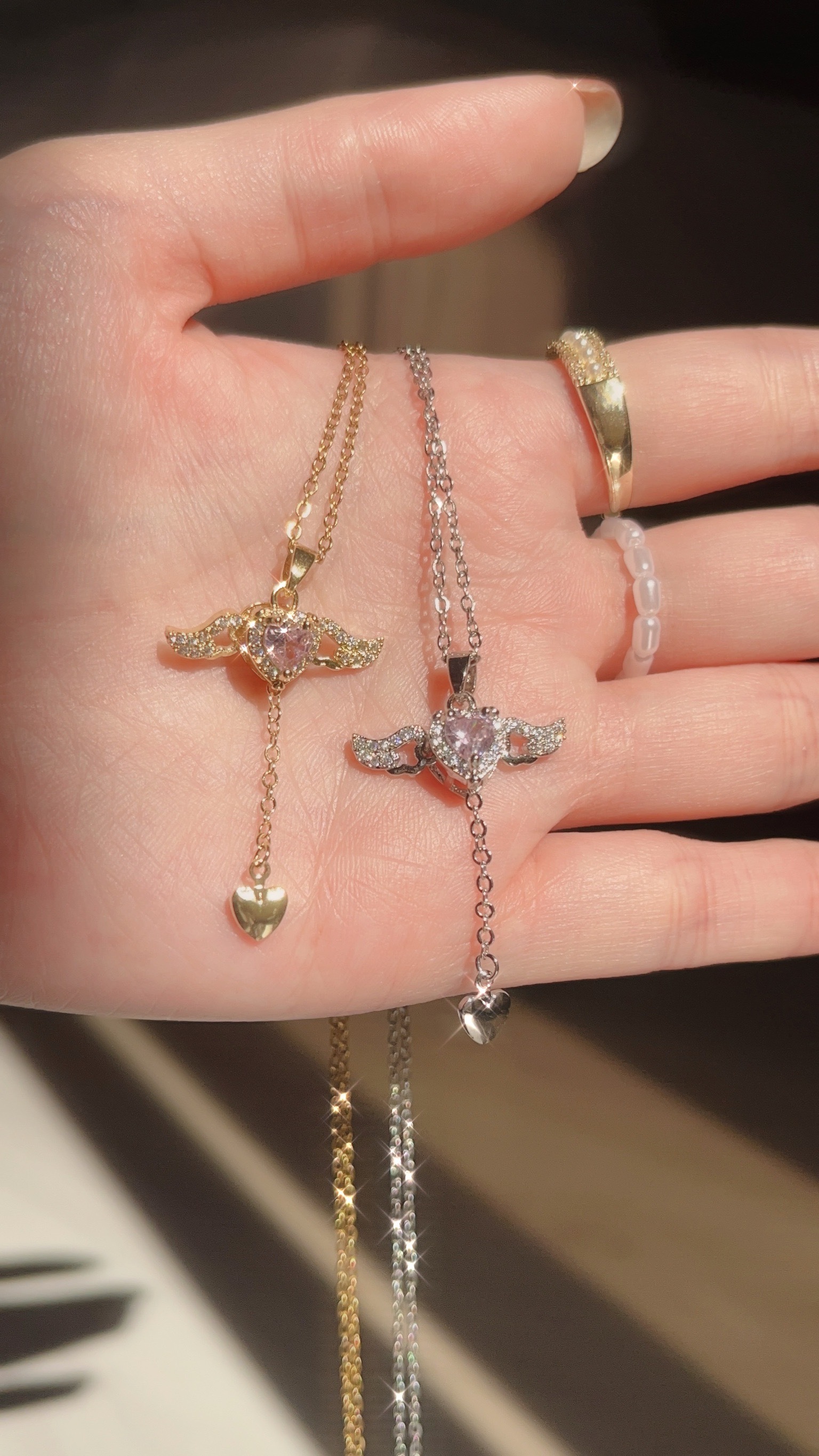 到會尖叫！超級漂亮華麗的魔法棒🪄 看到這條之後，最漂亮項鍊的排行榜要洗牌了 絕對有這條愛心魔法棒✨ 很像小櫻的星之杖，只是星星換成粉色愛心 更可愛了💗(⁎⁍̴̛ᴗ⁍̴̛⁎)  從愛心垂下的鏈條，結尾是一個小愛心，超可愛的細節.ᐟ.ᐟ ⭐️最讓人驚豔的的大亮點是𖤐 把鏈條往下拉，翅膀會跟著飛翔🪽 太可愛了啦😍  翅膀跟愛心的邊框是滿鑽的 戴起來閃閃發光 好讓人心動！ 絕對是首飾盒必須擁有的一條美麗項鍊🌷