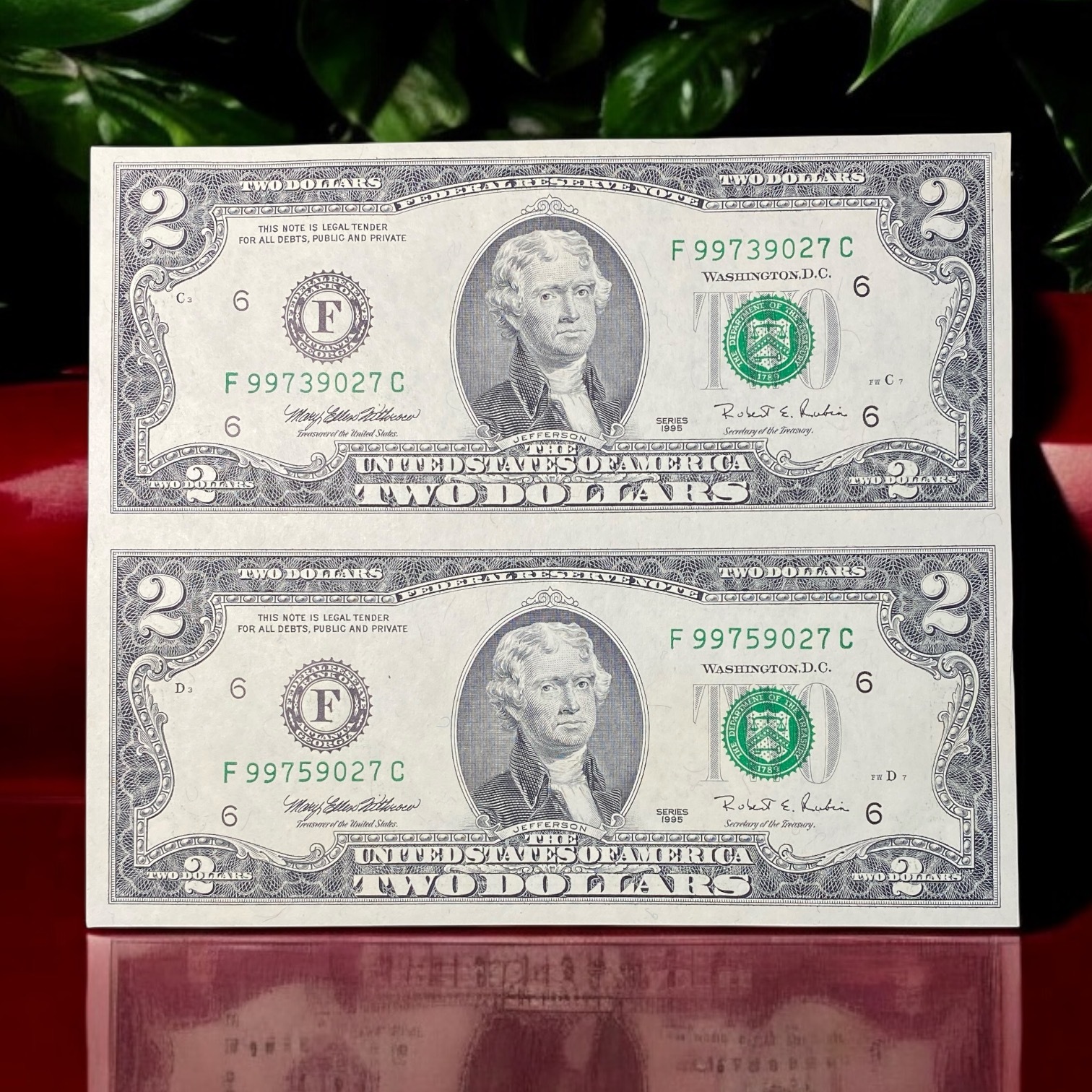 1995, two United States uncut two-dollar bills pair (AU-UNC condition) with serial numbers F99739027C and F99759027C.