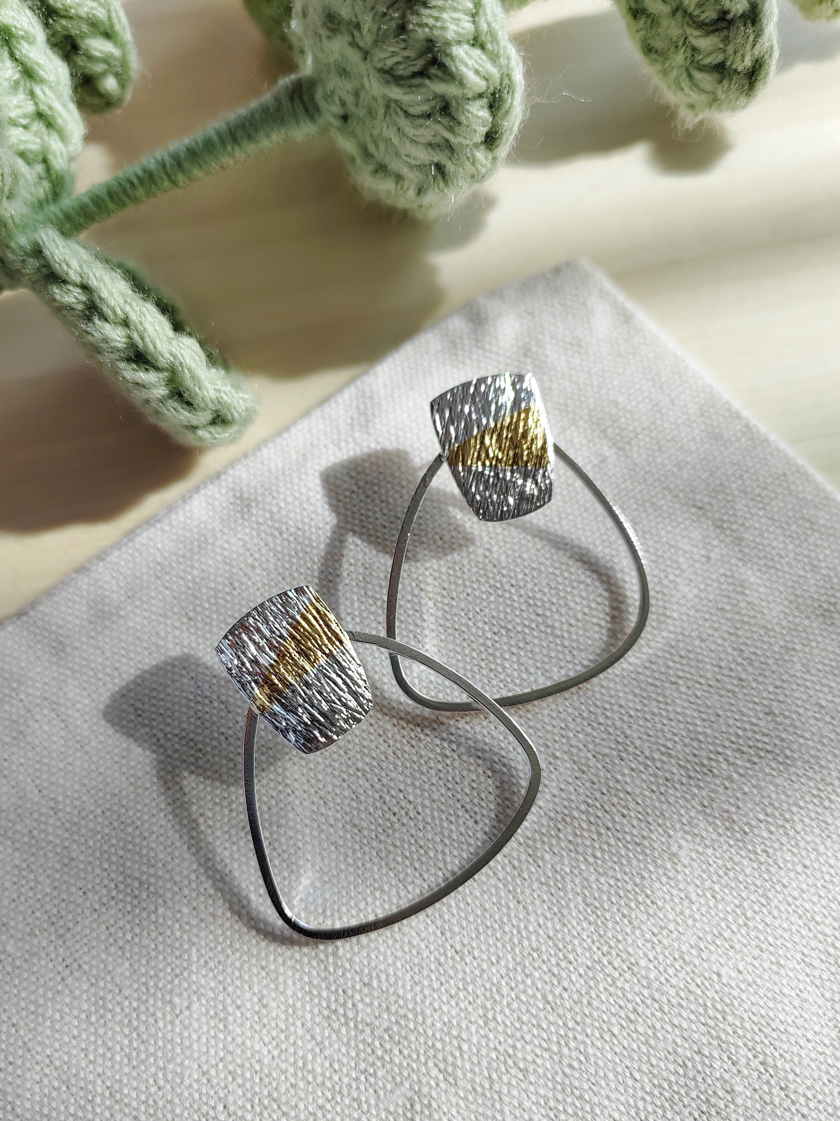 Handcrafted silver and gold fusion earrings by Handmade by W, featuring textured artisan design details
