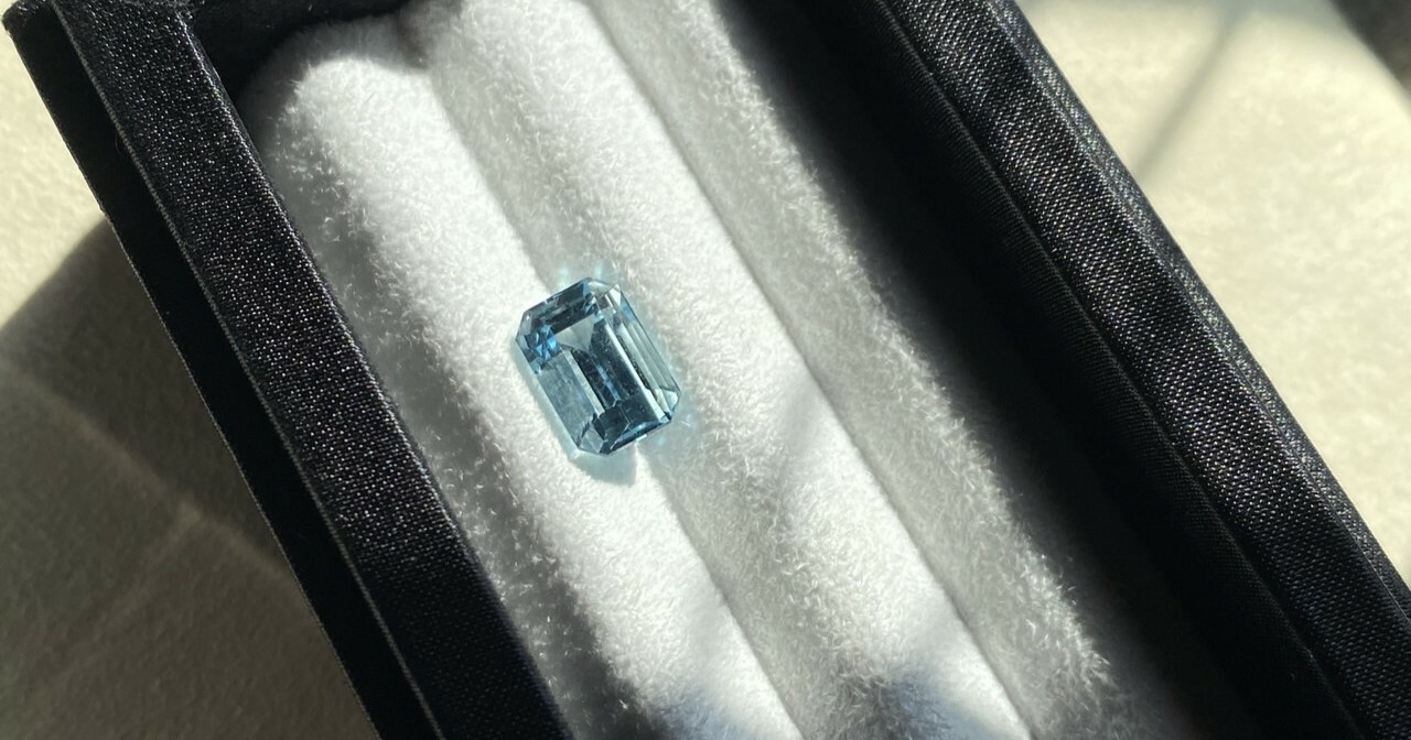 A 3.80 carat emerald-cut deep blue aquamarine.