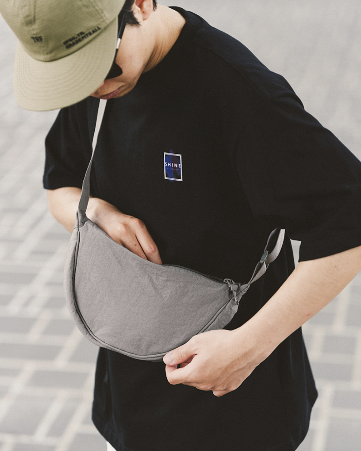 男模著尼龍半月型側背包灰色