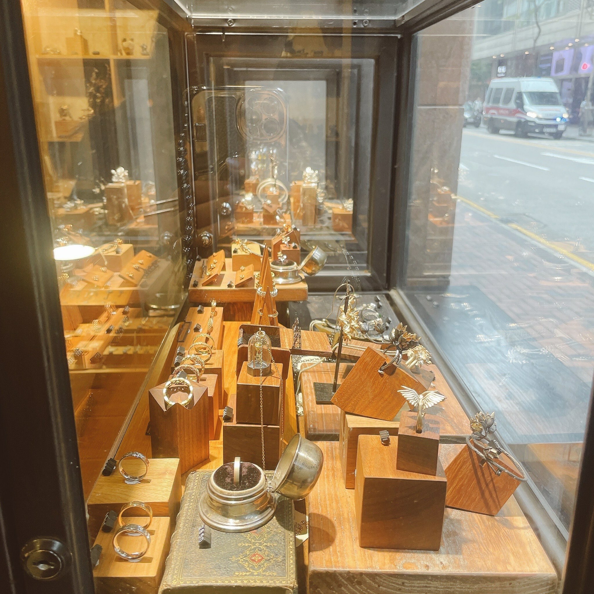 Silversmith香港銀飾店櫥窗展示,木質平台上陳列多款純銀戒指與立體造型銀飾,吸引街道行人目光