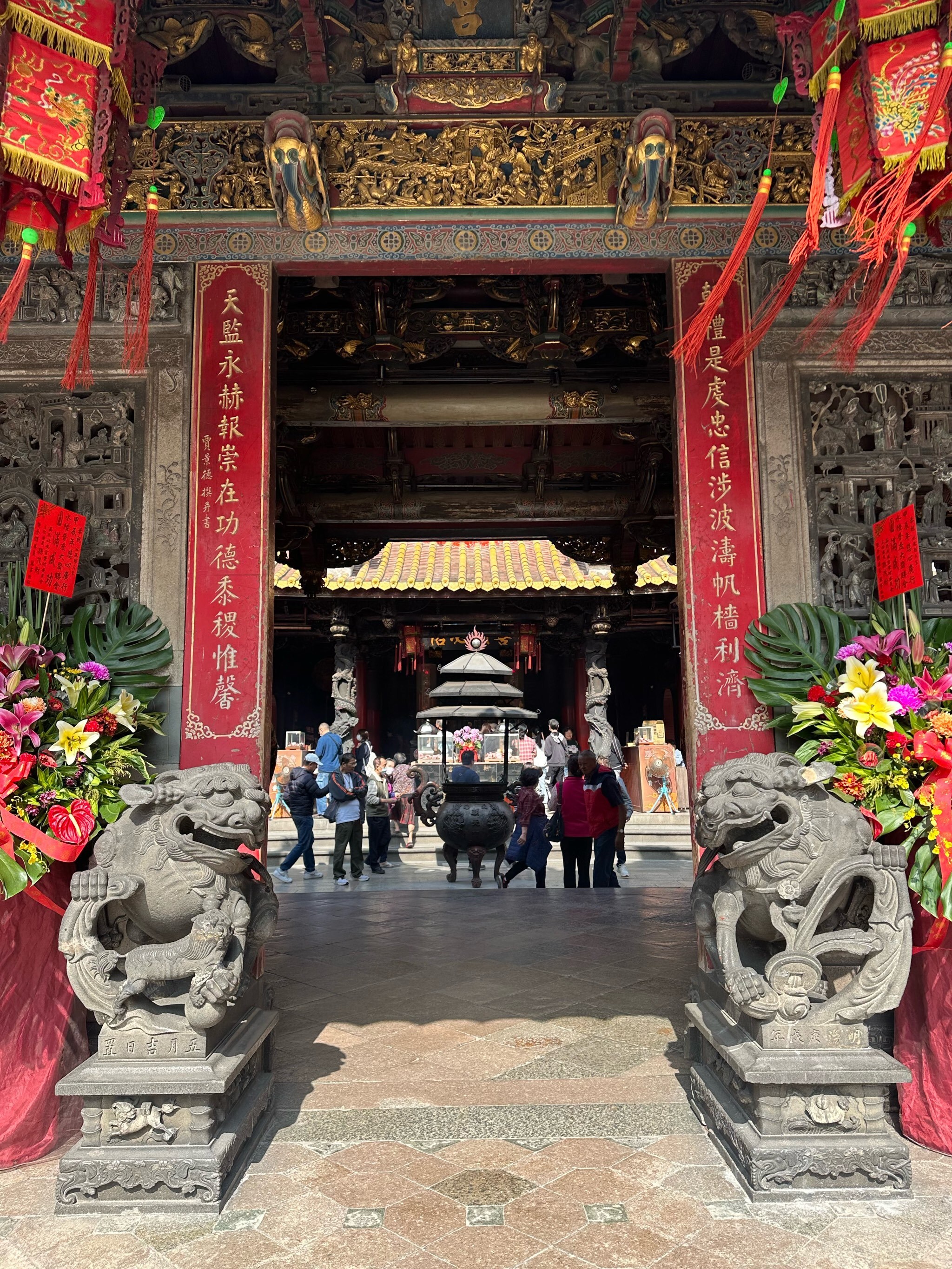 北港朝天宮正殿入口,石獅守門與香客入內參拜,廟內香火鼎盛