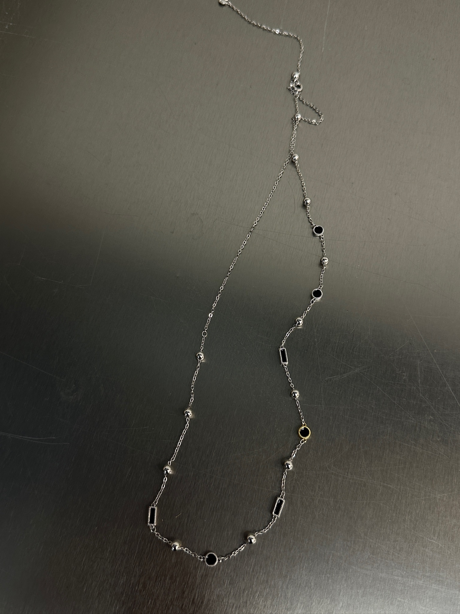 Black X gold necklace