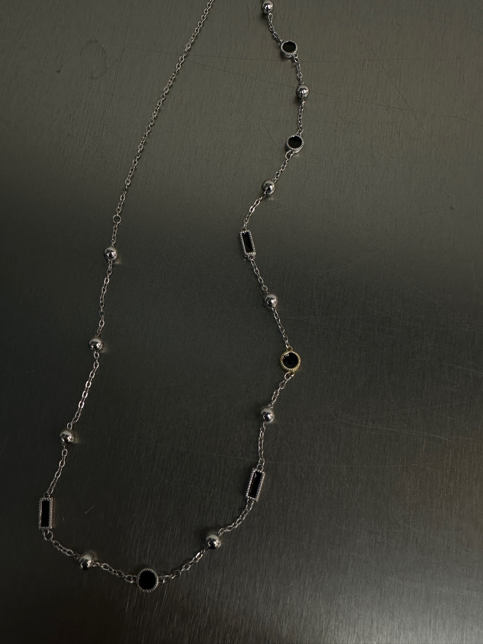 Black X gold necklace