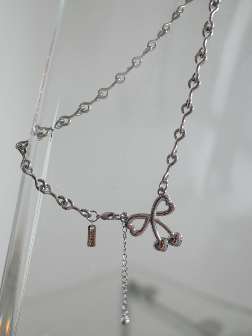 charming front-hook necklace with bow and heart detail