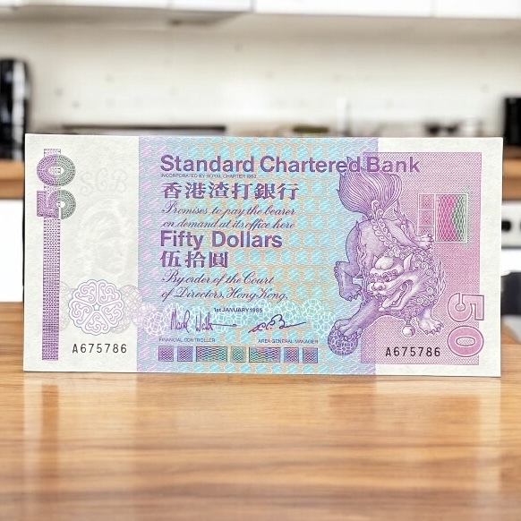1985 Standard Chartered Bank $50 Banknote First Year of Issue A675786 (AU-UNC)