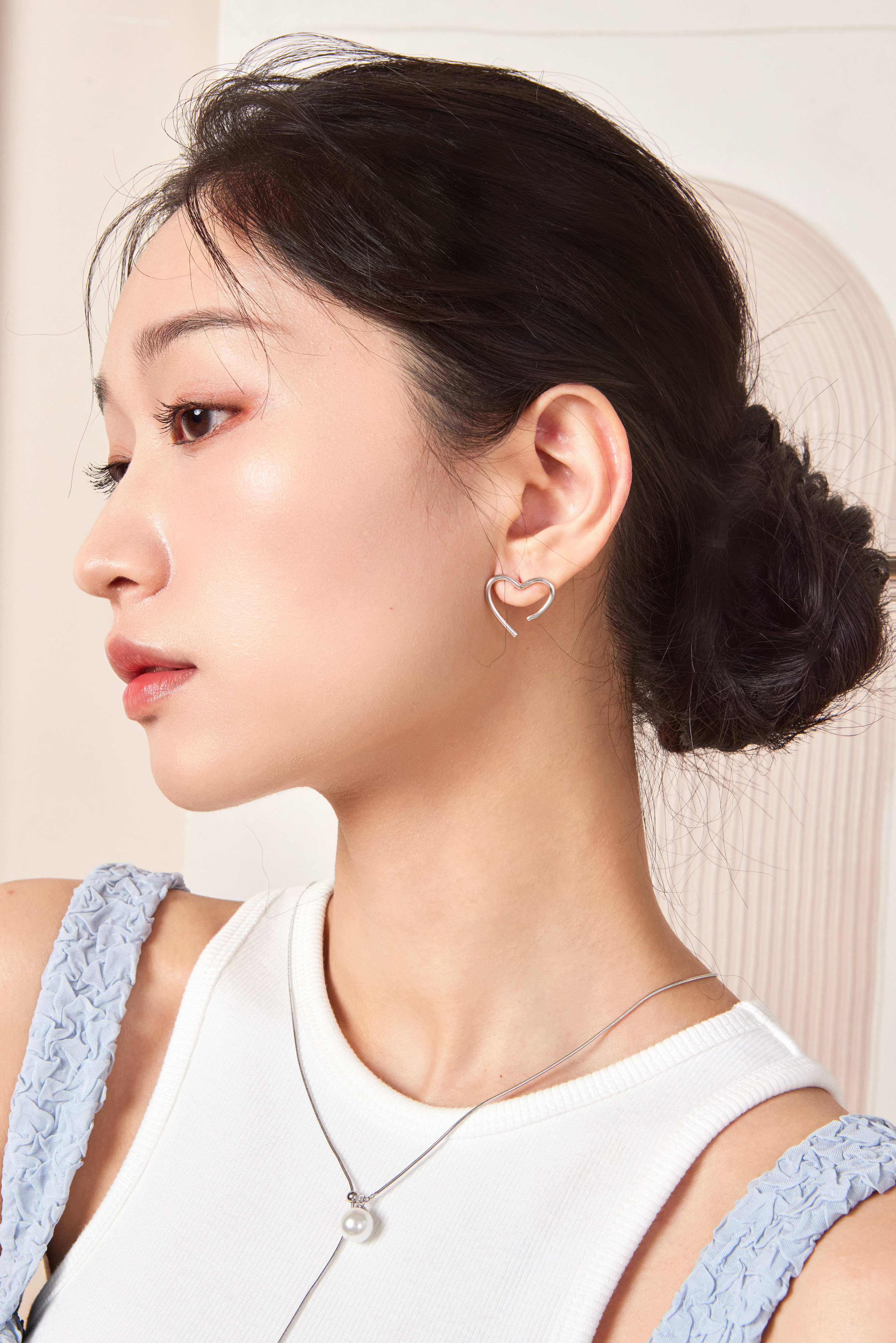 模特側臉照，耳環小巧點綴耳際，自然可愛