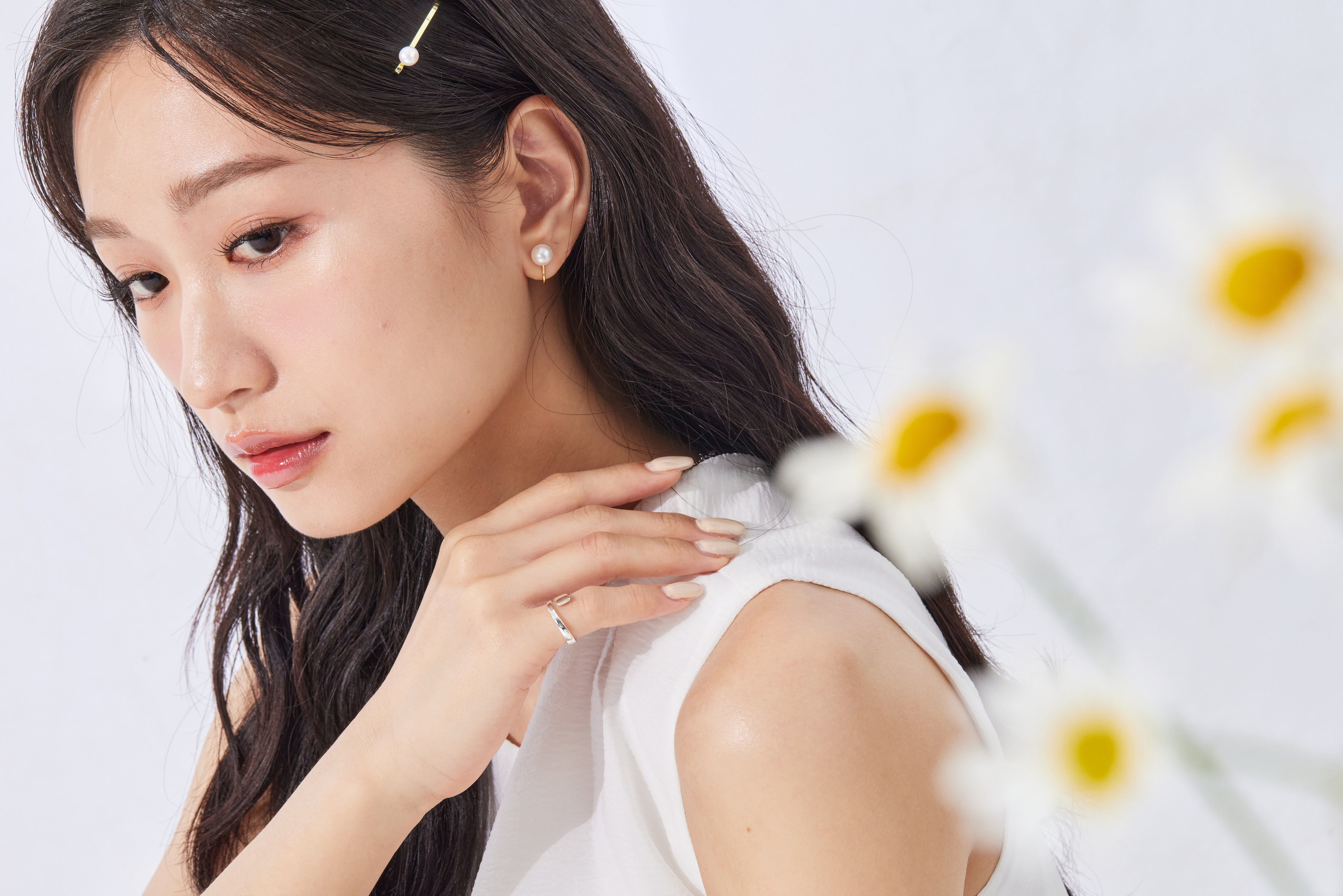 模特自然抬手，戒指於指尖閃耀光澤，整體造型清新俐落。