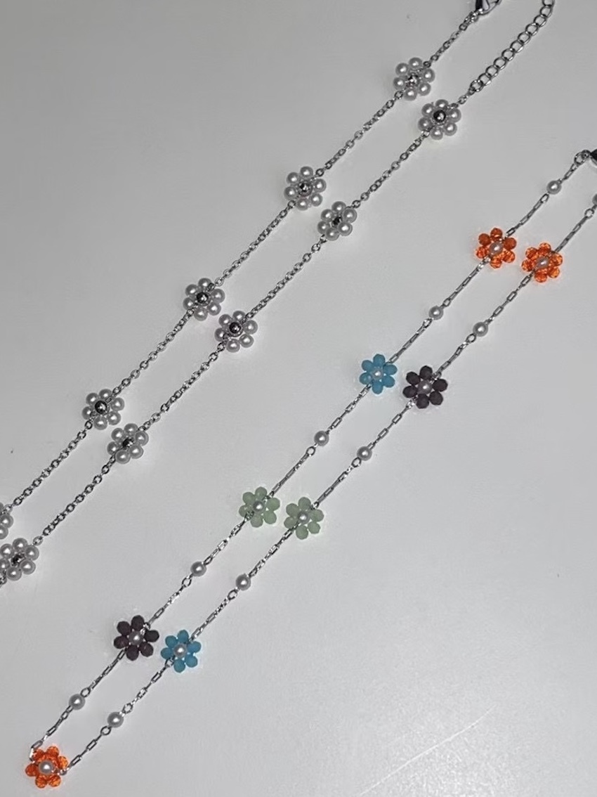 elegant beaded necklace with tiny floral charms