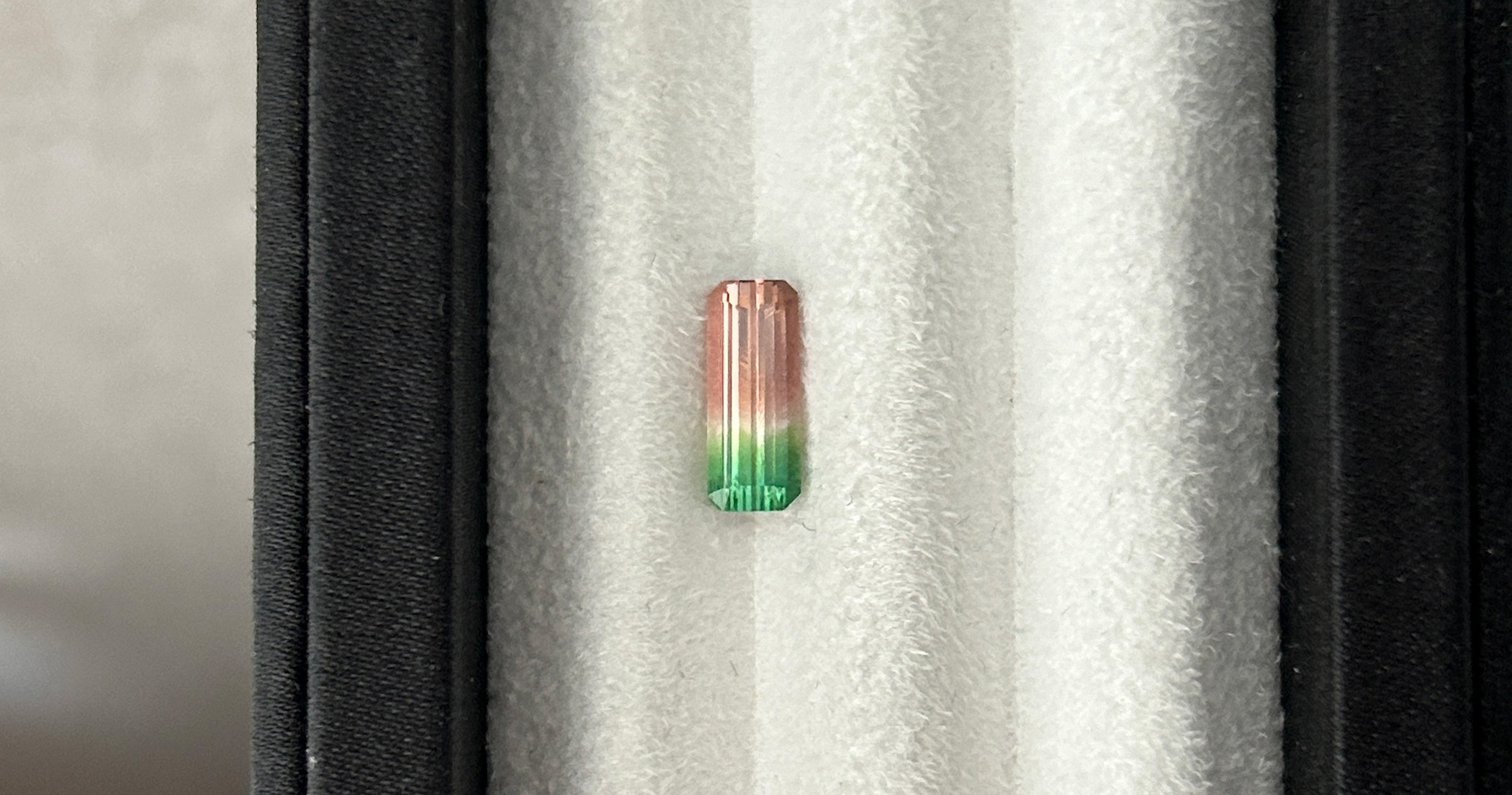 1.30-carat baguette-cut watermelon tourmaline with pink-to-green color zoning.