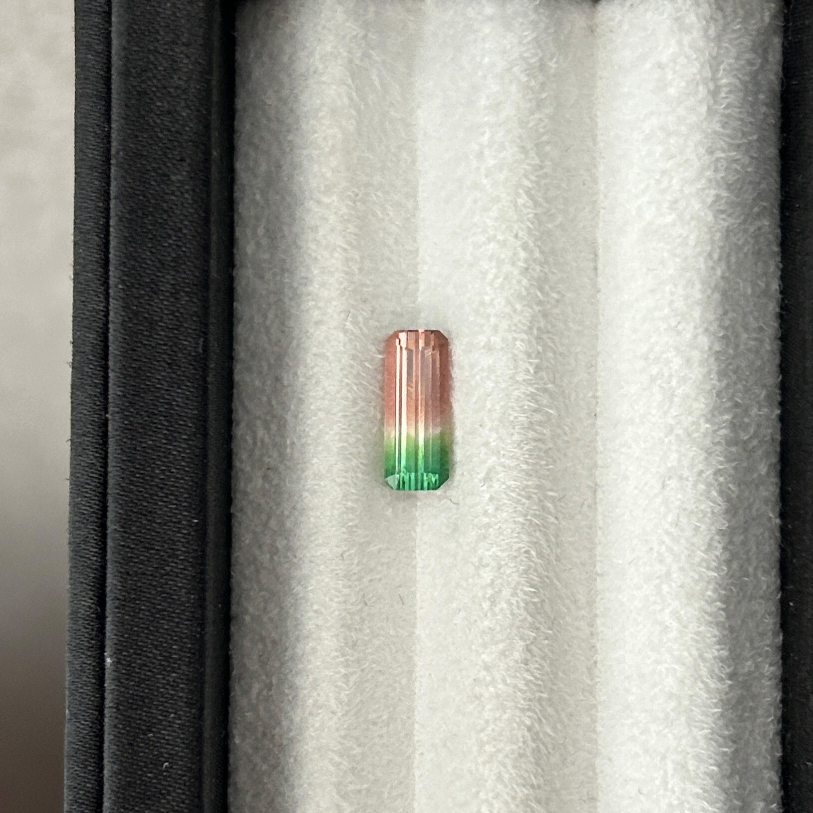 1.30-carat baguette-cut watermelon tourmaline with pink-to-green color zoning.