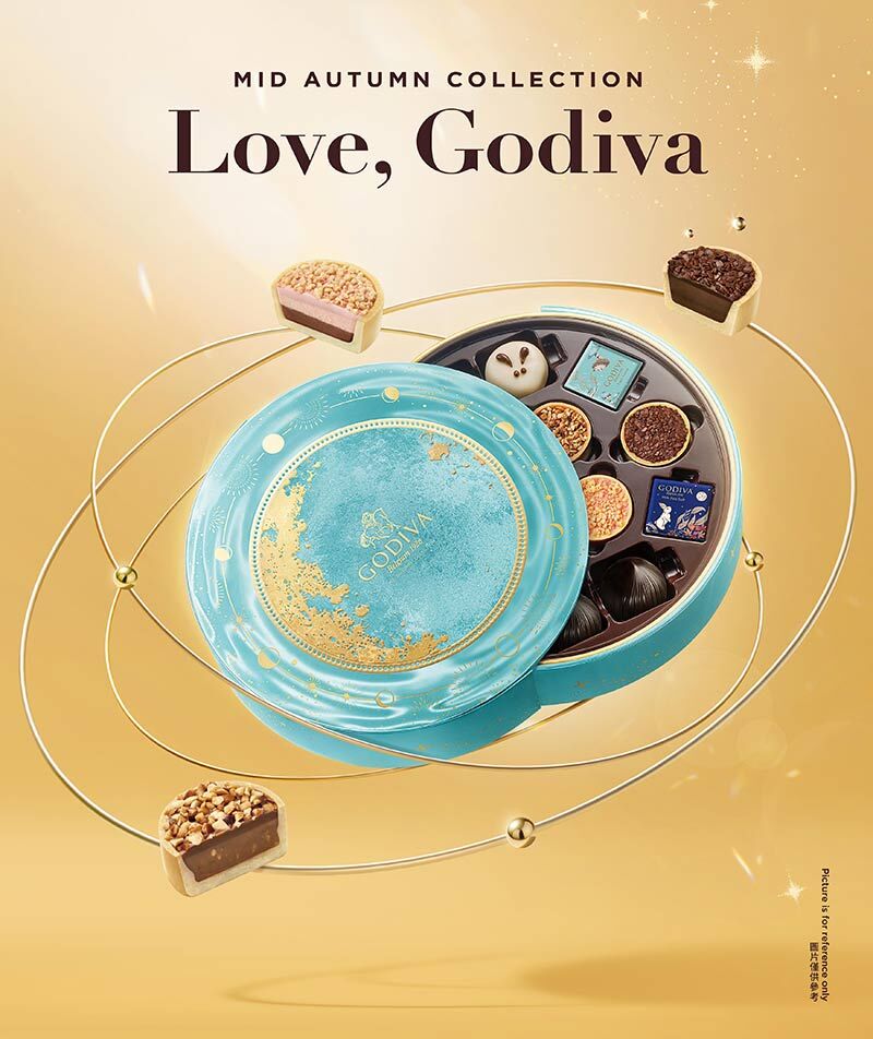 Godiva 中秋巧克力禮盒，夢幻藍色圓盒設計，內含多款精緻巧克力與限定造型，奢華質感搭配金色背景，是中秋送禮推薦的高端選擇。