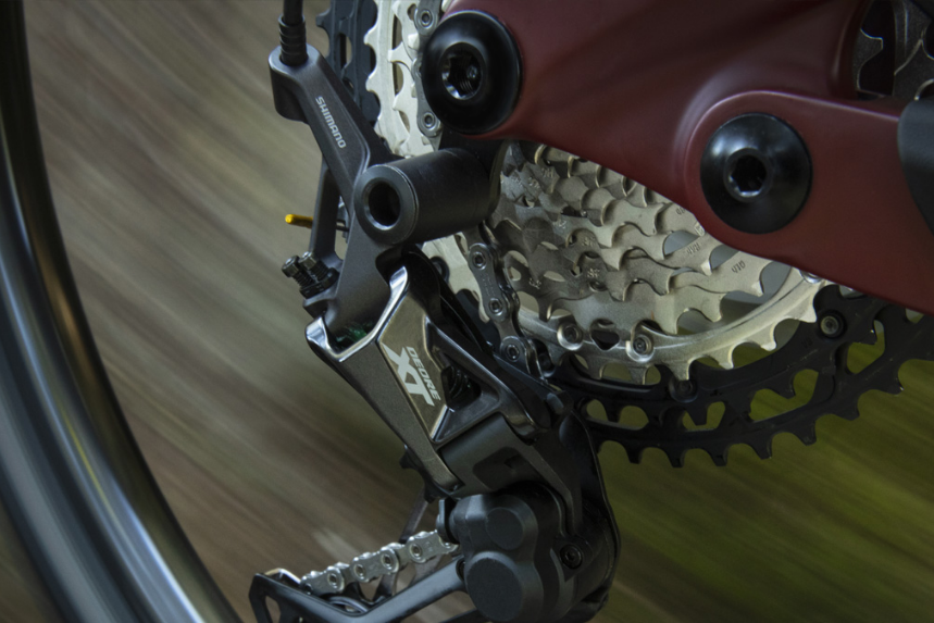 Shimano logo with drivetrain components in the background.