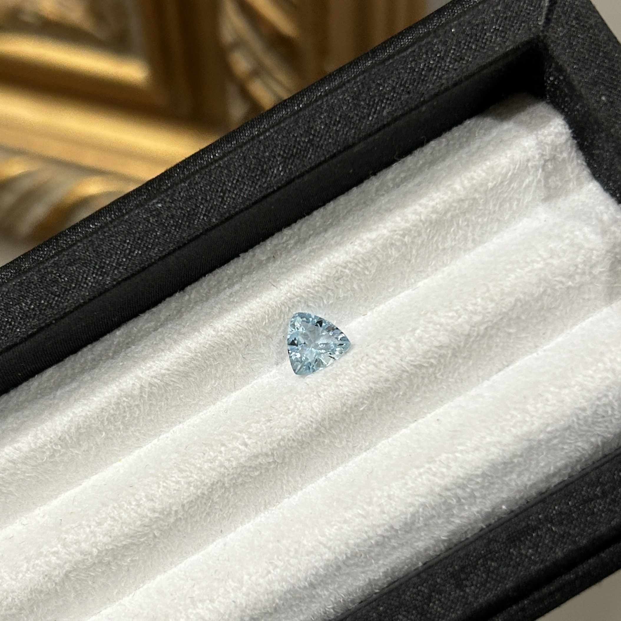 0.66ct triangle cut aquamarine in beautiful dark blue.