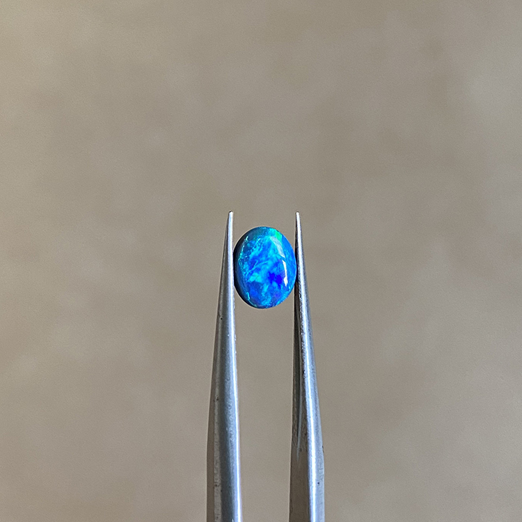 A 0.51-carat Lightning Ridge black opal showing vivid blue and green play-of-color.