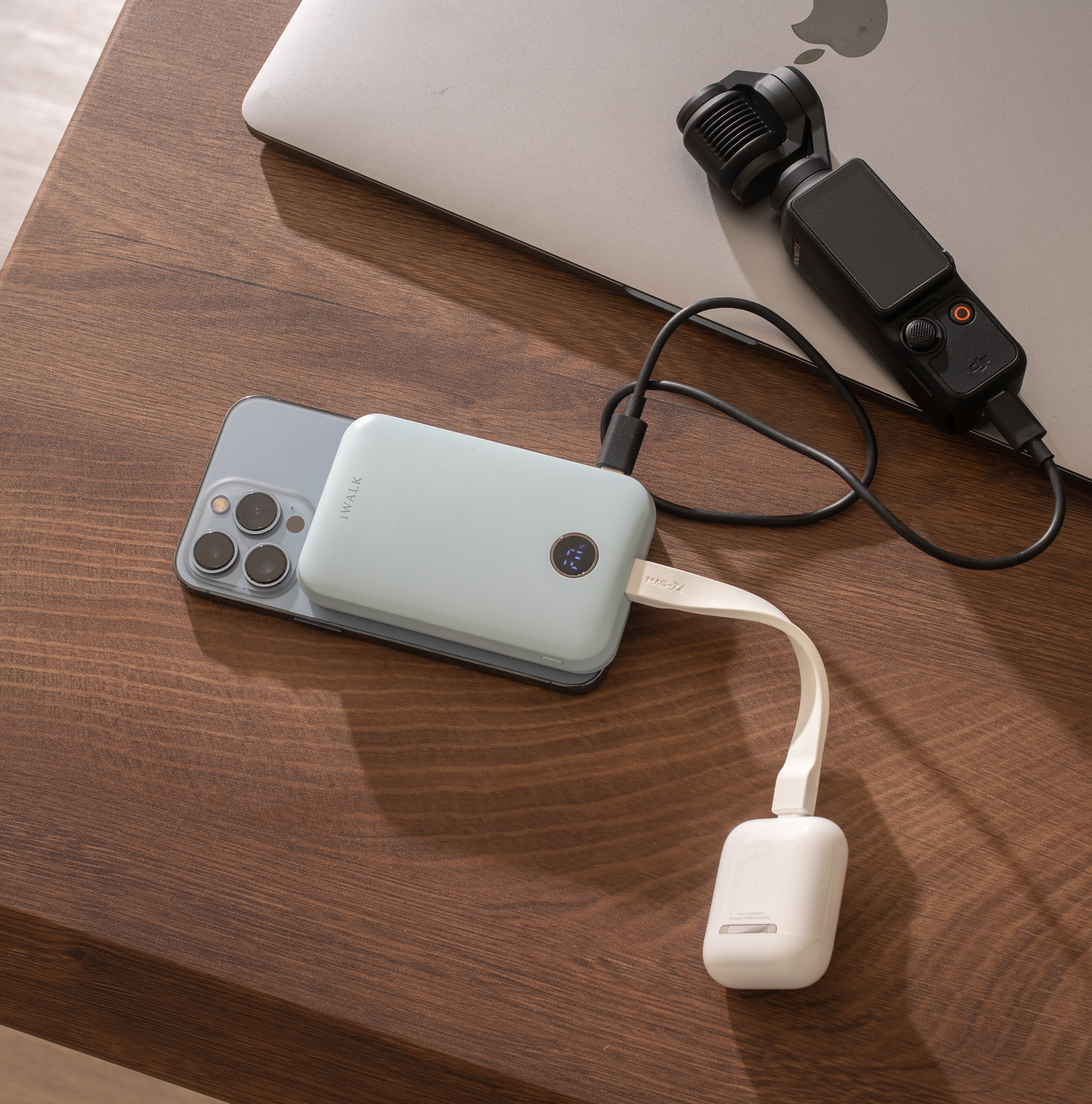 Pale green iWALK magnetic power bank attached to the back of an iPhone