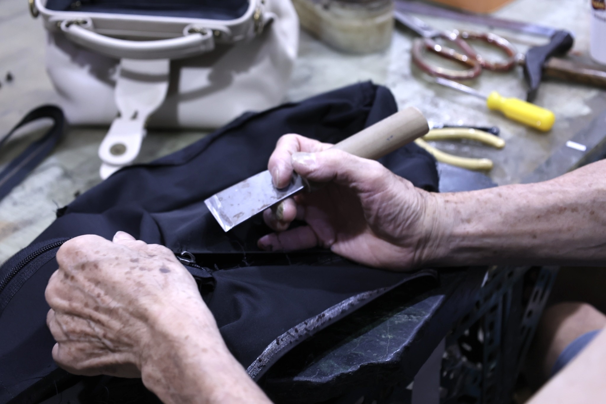 Trista 醫生包製作過程特寫:工匠用膠水塗抹於內裡接縫處,展現台灣手工工藝細節