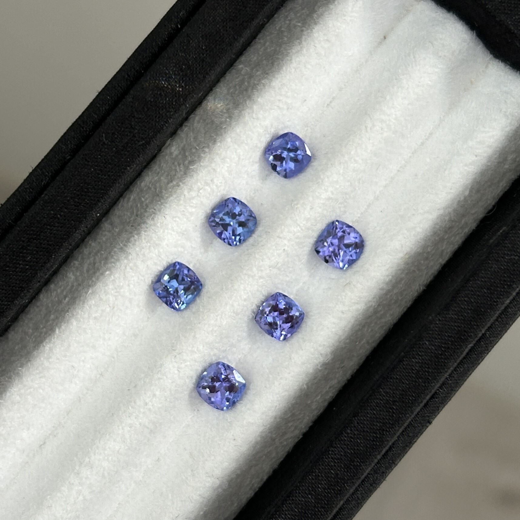 A set of vibrant violetish blue cushion-cut tanzanite, weighing 0.77-0.91 carat.