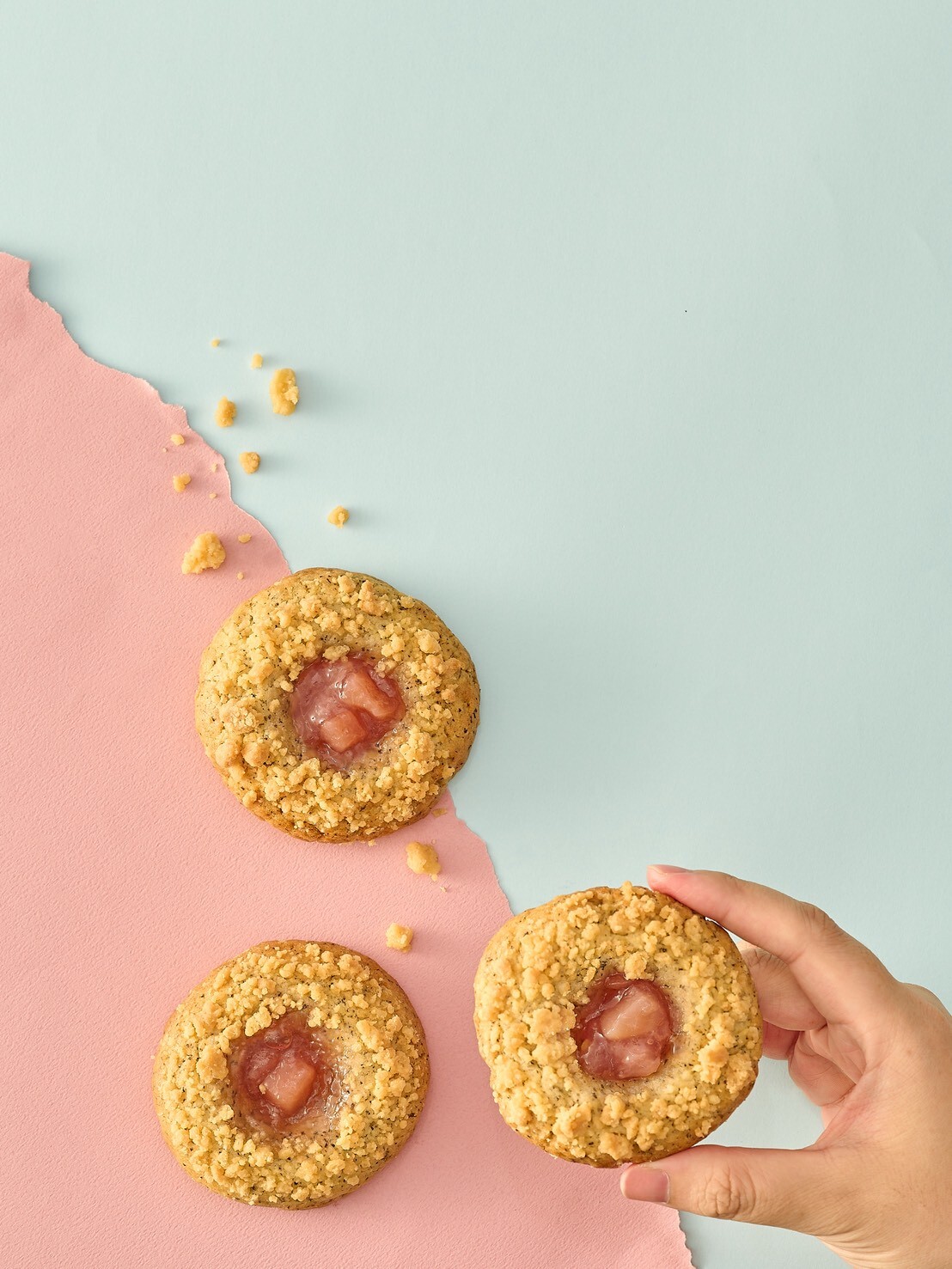 Sweetfull Peach Earl Grey Crumble Cookie pastel background hand holding cookie buttery crumble with peach jam gentle and elegant