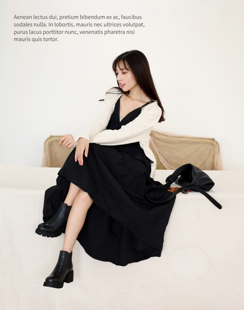 Sanly Joy 切爾西短靴穿搭照，模特穿著黑色真皮短靴搭配黑洋裝與針織外套，展現優雅舒適的日常居家風格。