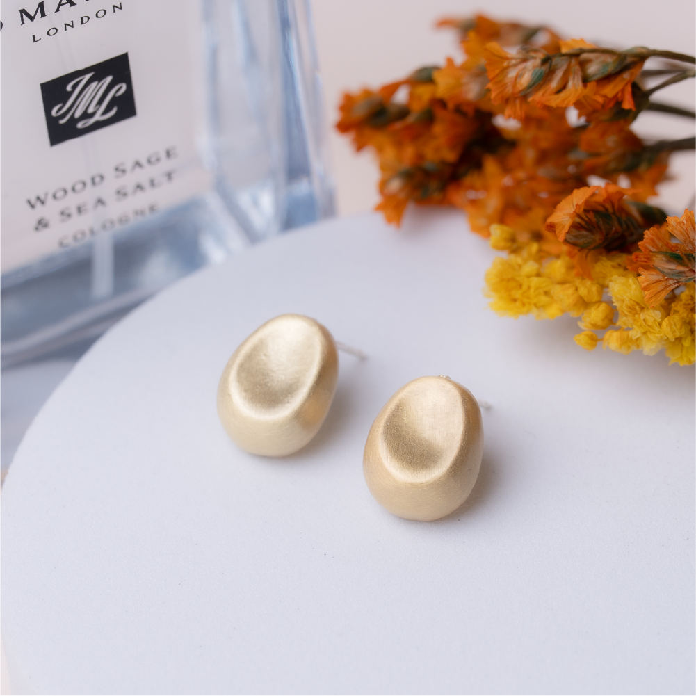 Bean-shaped gold and sterling silver earrings