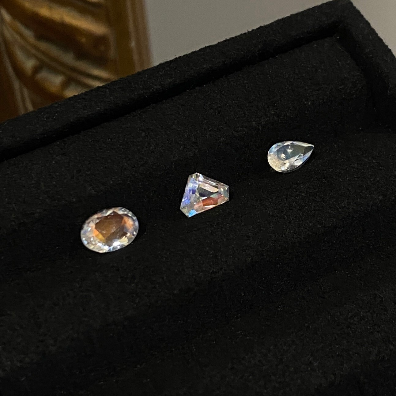 A set of Madagascar rainbow moonstones with oval, shield, and pear cuts.