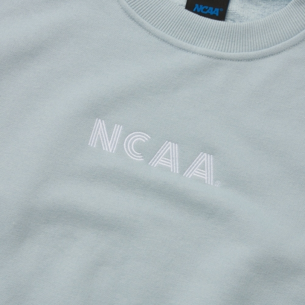 NCAA 大學T 馬卡龍藍 刺繡LOGO 落肩刷毛 短版 長袖 女 7452100281