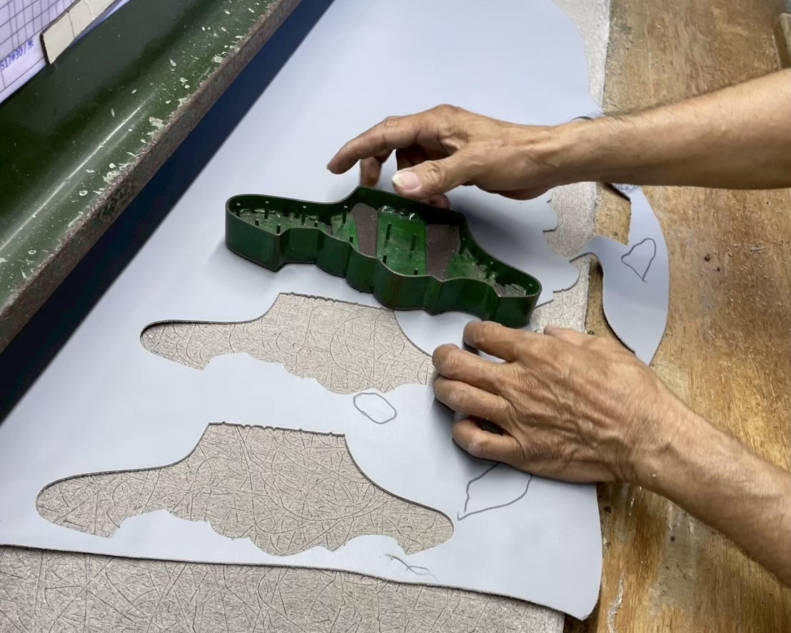 Sanly Joy 台南製鞋老師傅手工選皮過程，展示職人如何用觸感與經驗挑選頂級頭層牛皮，避開瑕疵並順應紋理裁切，是台灣手工真皮女鞋品質保證的第一道關卡。