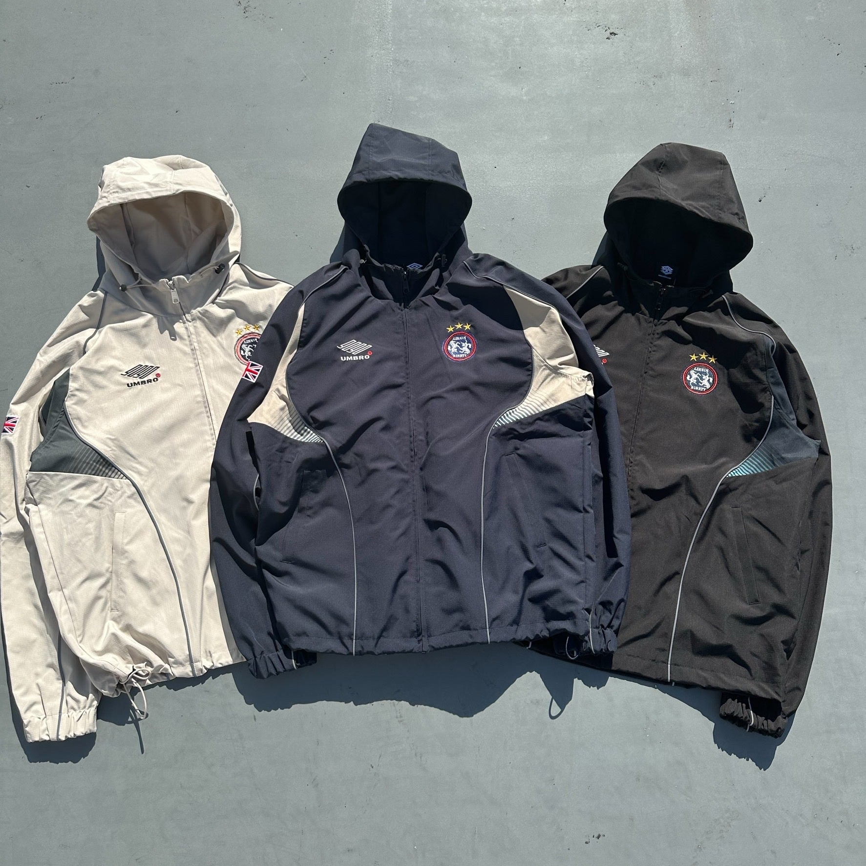 9090 × umbro Gradation Nylon Hooded Jacket