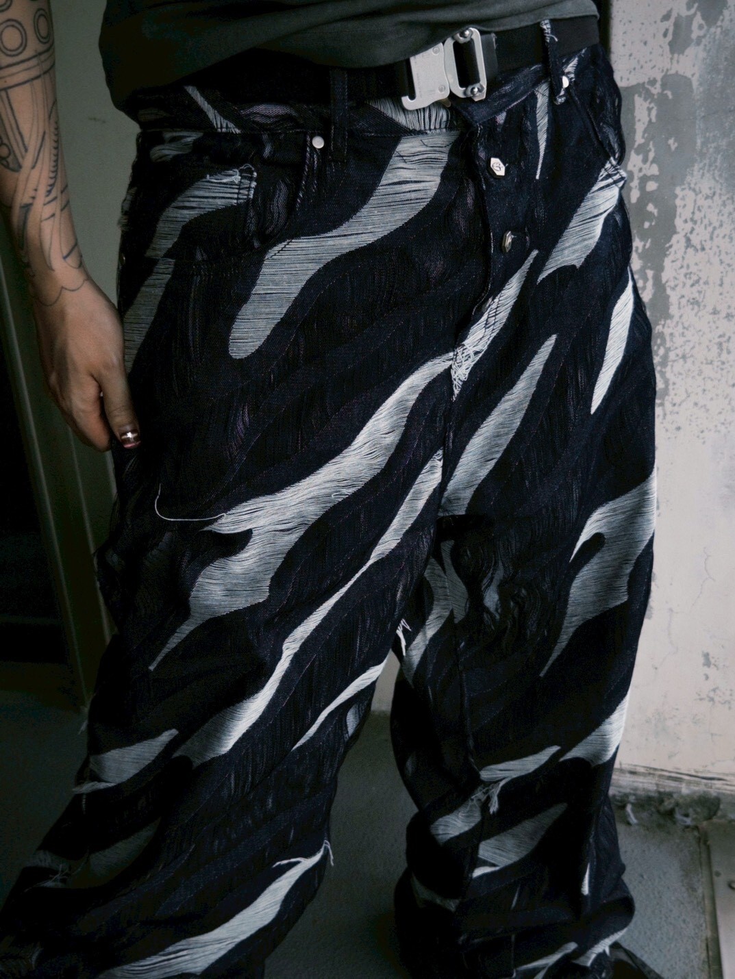 ETERNAL Black All-over Tiger Stripe Distressed Jeans with Frayed Edges, Metal Logo, and Antique Silver Buckles