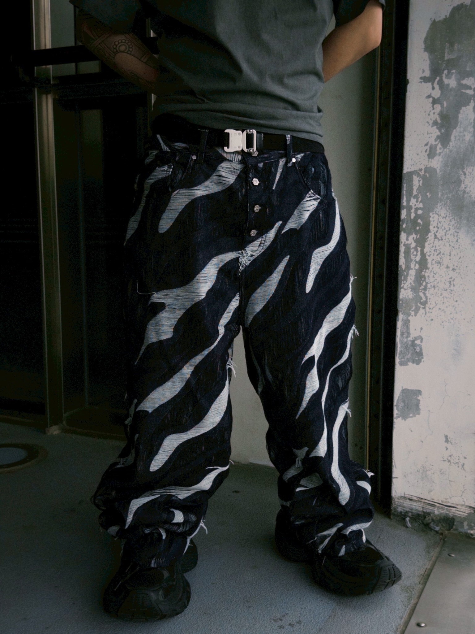 ETERNAL Black All-over Tiger Stripe Distressed Jeans with Frayed Edges, Metal Logo, and Antique Silver Buckles