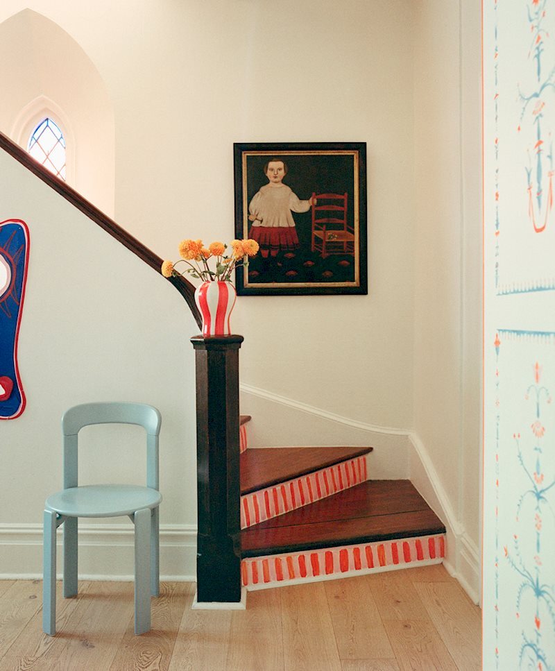HAY Rey Chair 淺藍色置於教堂宅邸樓梯旁,搭配 HAY Sobremesa 條紋花瓶,背景 Hannah Metz 手繪樓梯壁畫