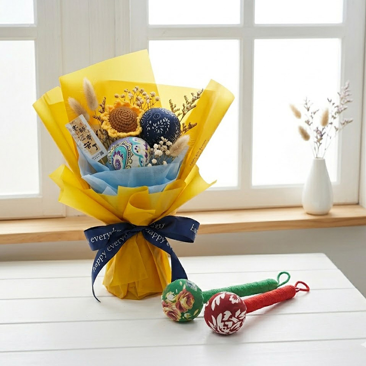 黃色艾草捶花束，內含艾草捶、向日葵與乾燥花，搭配藍色緞帶；前方另有綠柄與紅柄艾草捶。
